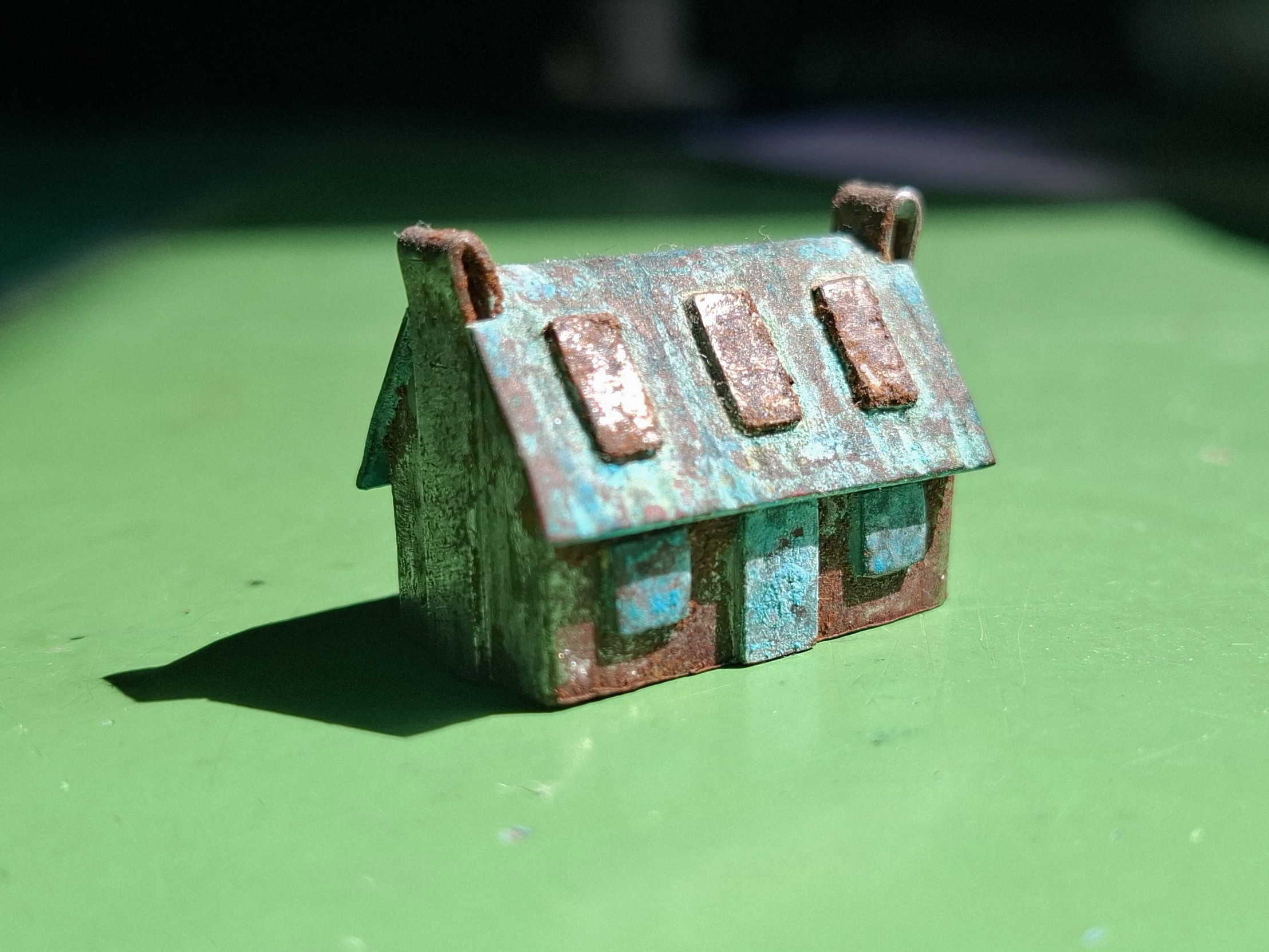small model cottage in oxidised copper and steel