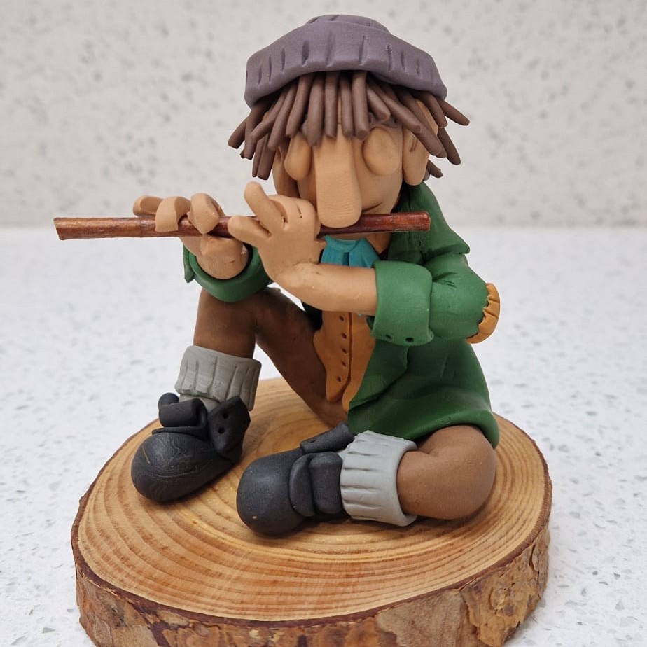 figure sitting and playing flute