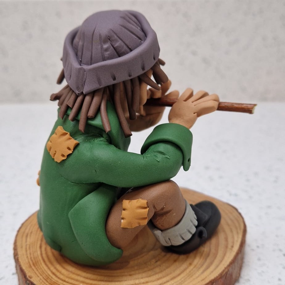 figure sitting and playing flute